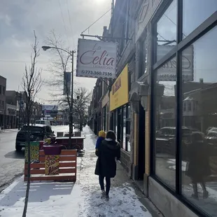 a woman walking down the sidewalk