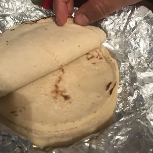 very thick and uncooked tortillas , they need a real tortillera lady