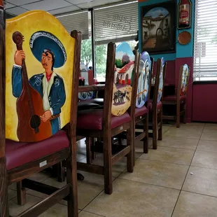 Beautifully decorated chairs with scenes of everyday life in Mexico