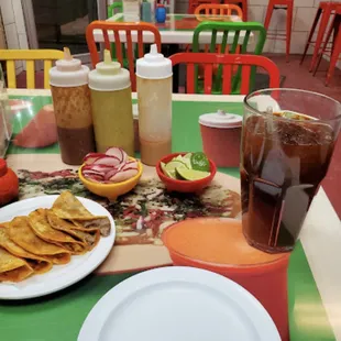 a plate of chips and a glass of soda