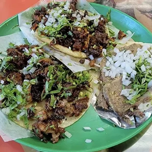 three tacos on a green plate