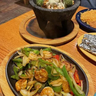Shrimp fajitas in front and Molcajete Jalisco topped with two Chile Toreados. Both were delicious!