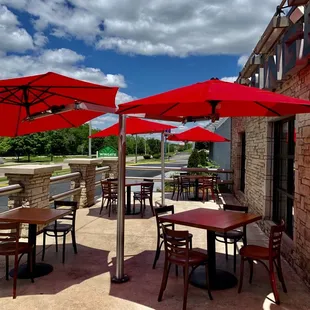 tables with red umbrellas