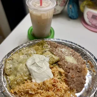 a plate of mexican food and a drink