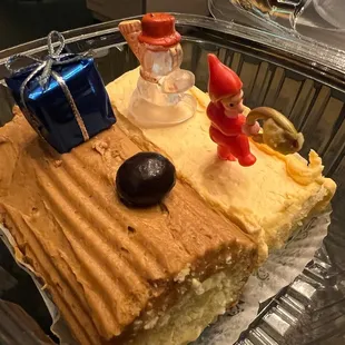 a piece of cake with a couple figurines on top
