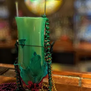 a mardi gras mask in a glass