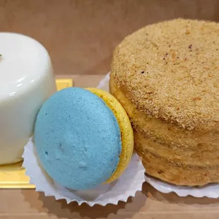 Left: Mini mango passionfruit mousse cake. Right: Mini honey cake. Center: Special edition Ukraine flag colors macaron