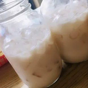 two jars of milk on a table