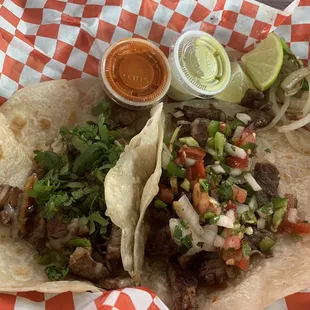 One bistek taco on flour and one asada taco on flour