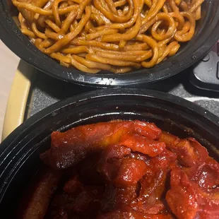 two pans of spaghetti and meat