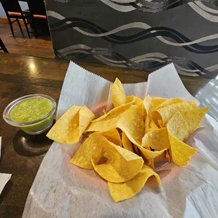 Complimentary chips with a green avocado/cilantro sauce