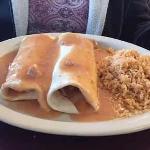 Two pork burritos with rice