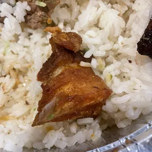 Pork skin in the Bandeja Paisa (grilled steak, pork skin, egg, sausage, corn cake, sweet plantain and avocado) for $17