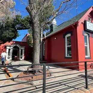 a red building with a tree in front of it