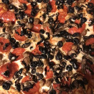 a pizza with pepperoni and olives