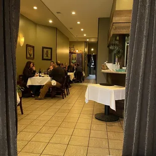 people sitting at tables in a restaurant