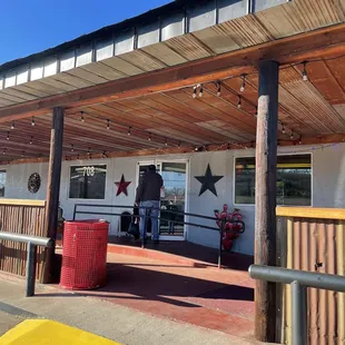 a man standing outside of a restaurant