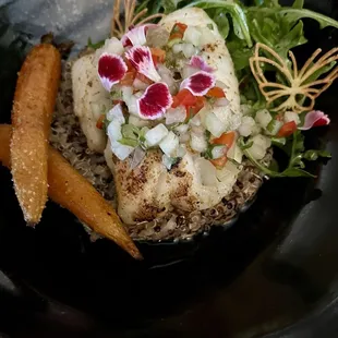 Chilean sea bass on a bed of quinoa with carrots and arugula