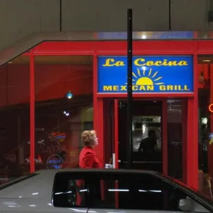 a woman standing in front of a restaurant