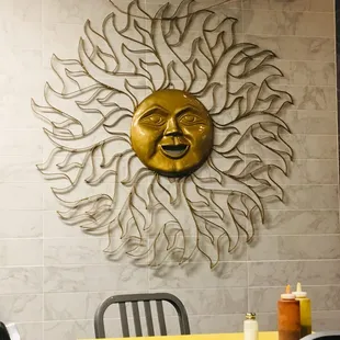 a sun face on the wall of a restaurant
