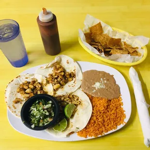 a plate of mexican food and a drink