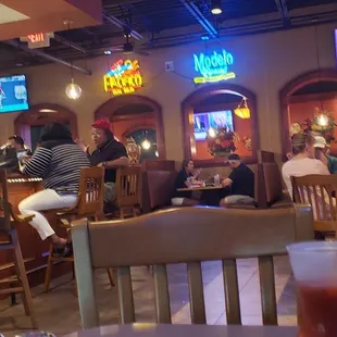 people sitting at tables in a restaurant