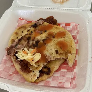 Pork and cheese pupusa, and a bean and cheese pupusa.