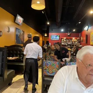 a man sitting at a table in a restaurant