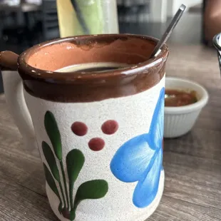 a coffee mug with a spoon in it