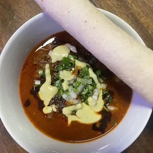 Birria de res with handmade tortilla.