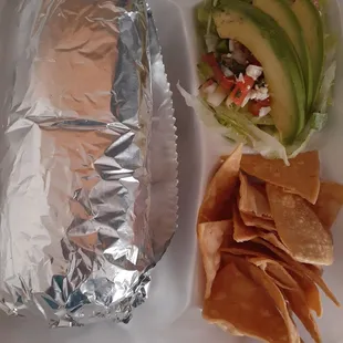 LARGE burrito comes with avocado salad, nachos and 4 different spicy sauces and sour cream (sauces not shown)