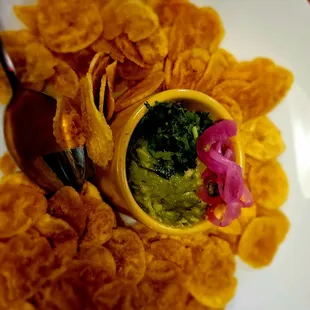 a bowl of guacamole and chips