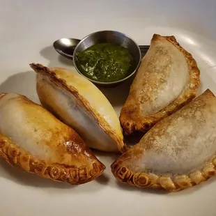 three empanadas on a plate