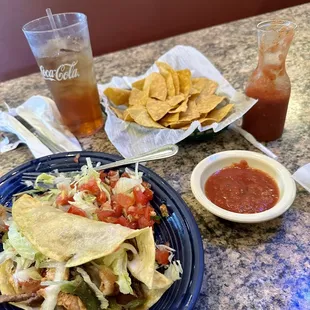 a plate of nachos and a drink