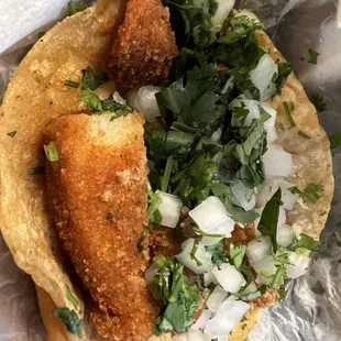 Fish taco with onion and cilantro