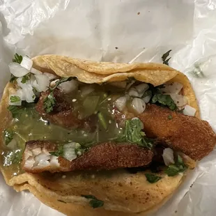 Fish taco with onion and cilantro