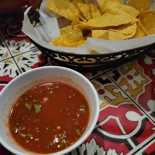 a bowl of tortilla and a bowl of salsa