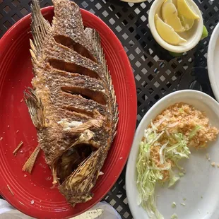 Fried Tilapia with rice and lettuce.