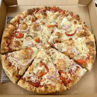 Custom pizza with grilled chicken, red peppers and red onion