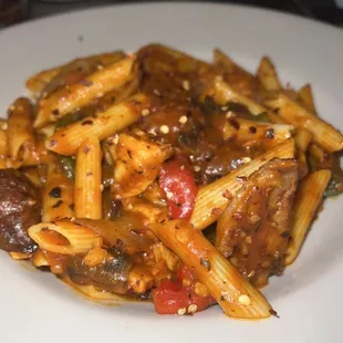 a plate of pasta with meat and vegetables