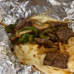 Beef fajita taco on flour tortilla.