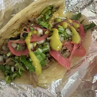 Flour tortilla with shredded beef, pickled onions and green sauce. 5/5