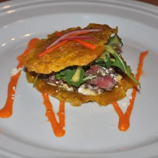 Carne Asada Patacon (Crispy Smashed Green Plantain Sandwich) with Creamy Roasted Red Pepper Sauce