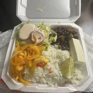 Sides of rice salads and beans with fresh cheese