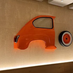 an orange car on the wall