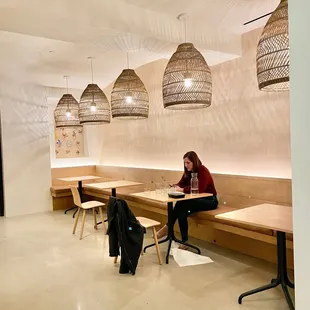a woman sitting on a bench in a restaurant