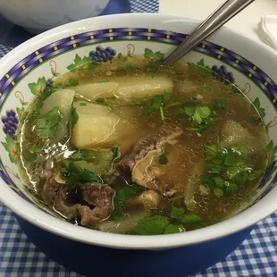 a bowl of soup with meat and vegetables