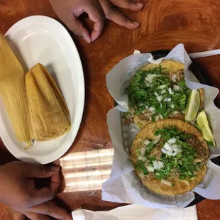 Tamales, carnitas tacos, and empanada de quest (cheese)