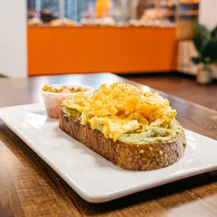 Avocado Toast with Egg - Sourdough toast with avocado, scrambled egg, paprika, garlic &amp; sesame seeds.