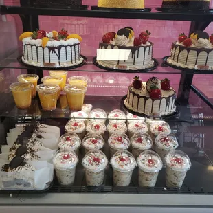 a display of cakes and cupcakes